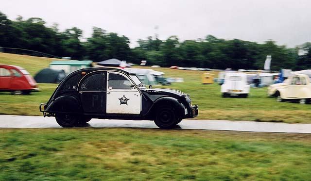 Zoom-out to see the back of a  Citroen 2CV in the grounds of Floors Castle,  Kelso, in the Scottish Borders  -  during the World 2CV Meeting held at Kelso, July 2005