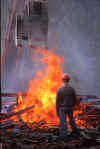 Central Demolition - a worker supervises the burning of material during the demolition of Edinburgh's Northern General Hospital