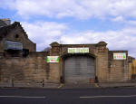 Christmas Tree Warehouse at Canonmills  -  March 1996, with the signs still on display from December 1995  -  Entrance still standing but building behind demolished