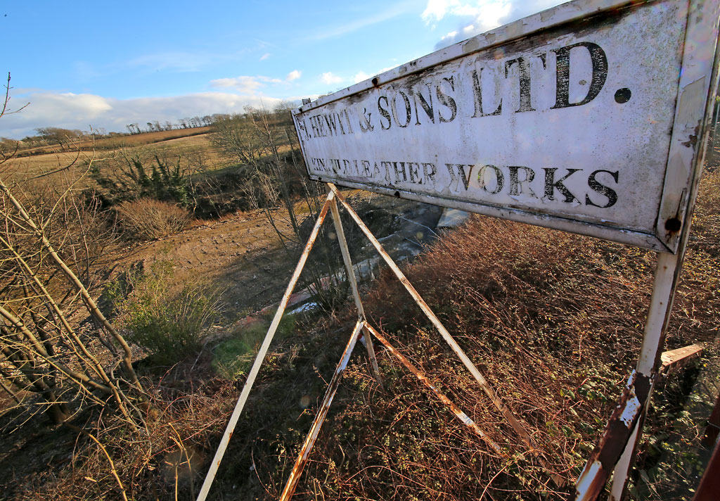 The site of Hewit & Sons' Leather Works beside the Water of Leith at Currie.  The company had stopped trading and their works had been demolished by the time that this photo was taken in 2013.