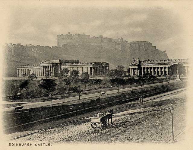 Zoom-in to the picture on the front of a postcard by an unidentified publisher  -   Looking to the south-west, across Princes Street towards the National Galleries and Edinburgh Castle on Castle Hill