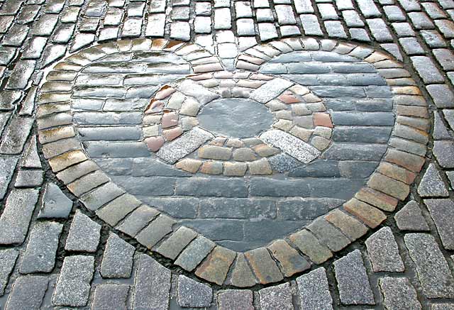 The Heart of Midlothian , set in the cobbles near the NW corner of St Giles Church in High Street, Edinburgh