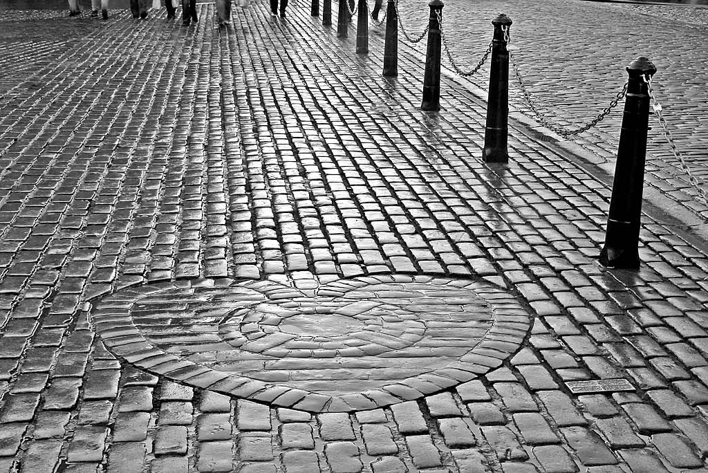 The Heart of Midlothian , set in the cobbles near the NW corner of St Giles Church in High Street, Edinburgh