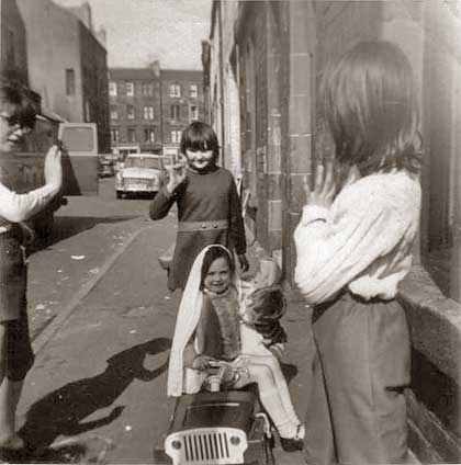 Fiona Logan with her sister Julie and brother Malcolm playing at getting married, at Murano Place, around 1968