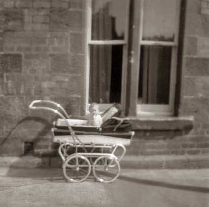 Fiona Logan in her pram outside 16 Murano Place, around 1962