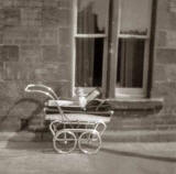 Fiona Logan in her pram outside 16 Murano Place, around 1962