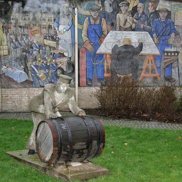 A Sailor rolls out a Barrel, in front of a mural on a gable end at North Junction Street, Leith, depicting Leith's historic connections with the sea