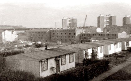 Oxgangs Avenue - Prefabs in the foreground and high-rise flats in the background.
