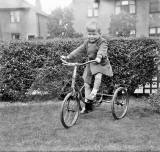 Douglas Roberts on his tricycle in his garden at Pilton Avenue  -  early-1950s