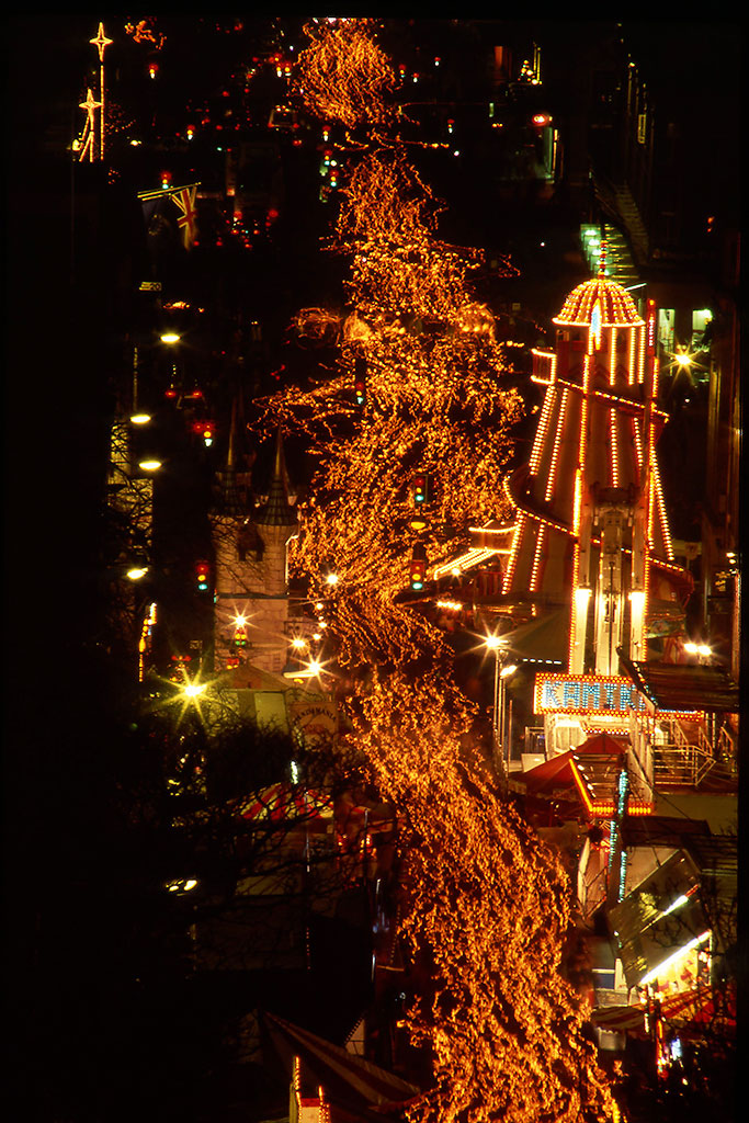 The torchlight processsion passes along Waterloo Place on its way to Calton Hill. This photo looks down from Calton Hill on the precession and the helter skelter inWaterloo Place.