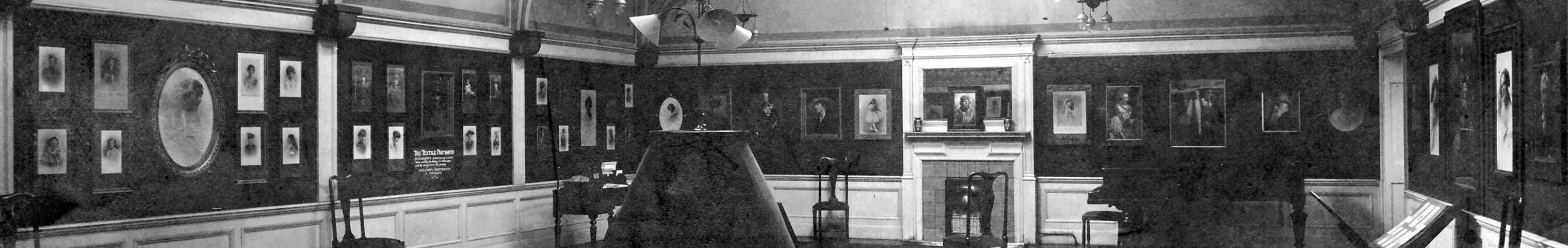 Zoom-in to see the photographs on the walls of Louis Saul Langfier's studio.  Was this in Glasgow or Edinburgh or London?