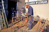 Alexander McLennan working in the yard outside his blacksmiths workshop at Dunedin Street, Powderhall