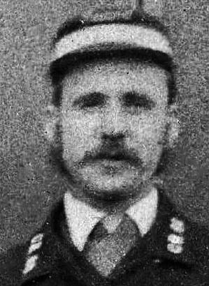 Detail from a photograph of a group of Railway Workers  -  Where and when might this photo have been taken?